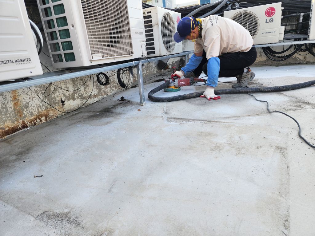 실외기 하부 모서리를 그라인더로 정밀 연삭하는 클로즈업