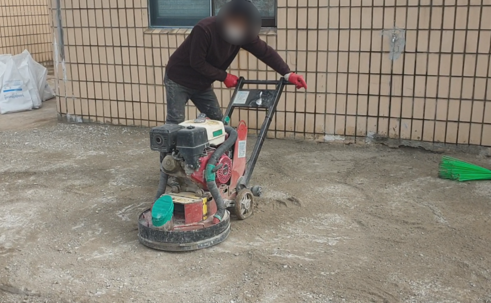연삭기로 벽체 근처 바닥면을 정리하는 클로즈업